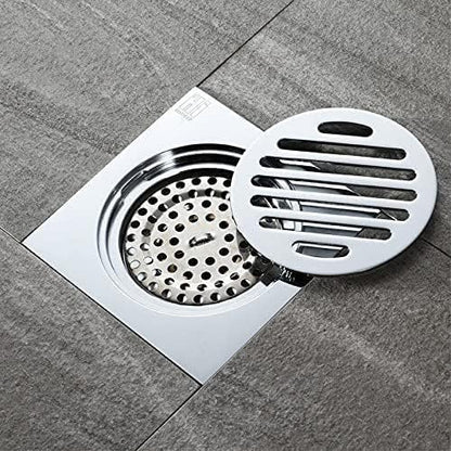 Rejilla desagüe ducha de acero inoxidable 10x10 cm con marco para instalación en piso de baño moderno.